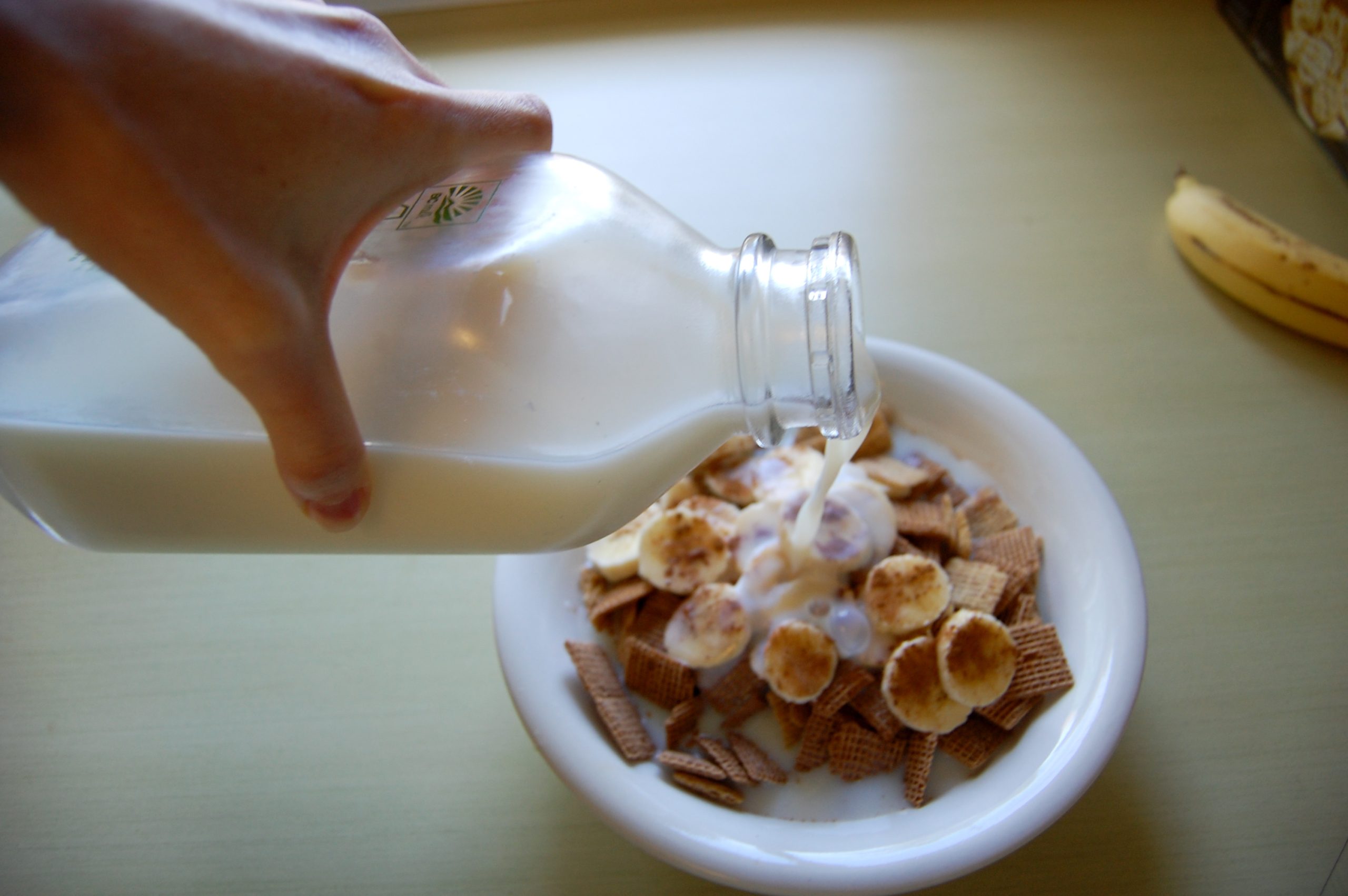 skim_milk_poured_into_cereal_bowl