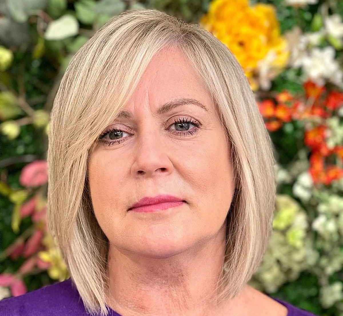 elegant-bob-cut-with-a-side-part-and-bangs-for-women-over-50