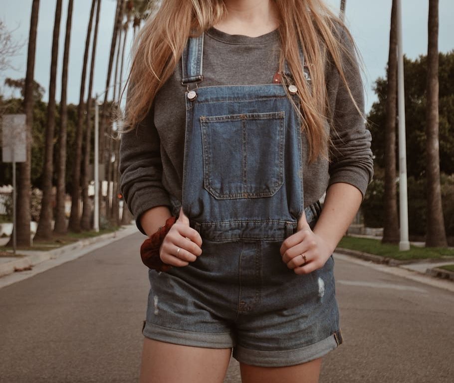 woman-wearing-dungarees-standing-on-road