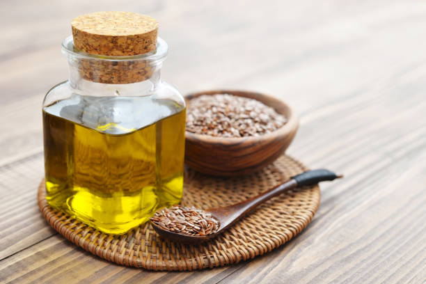 flax-seeds-and-oil-in-bottle-on-wooden-background