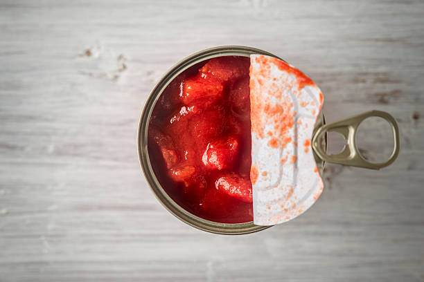 chopped-tomatoes-in-the-metal-can-in-the-white-wooden-table-top-view-horizontal