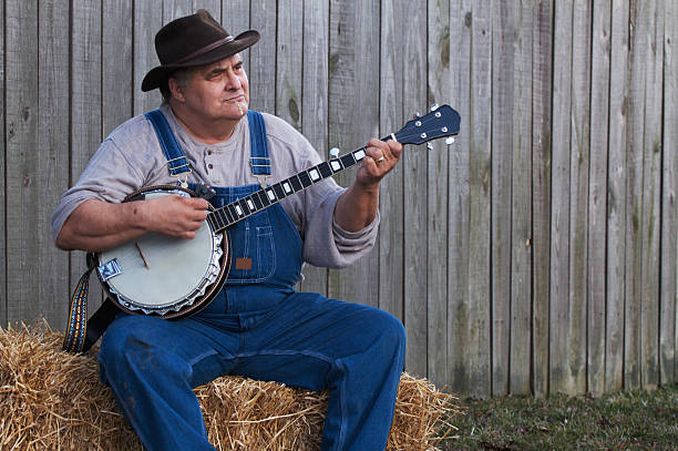 a-bluegrass-country-banjo-player-sitting-on-a-haystack-at-dusk