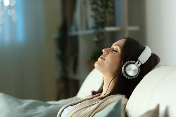 relaxed-woman-listening-to-music-with-headphones-in-the-night