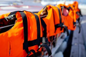 a-few-bright-orange-life-jackets-on-the-yacht-fence-high-quality-photo