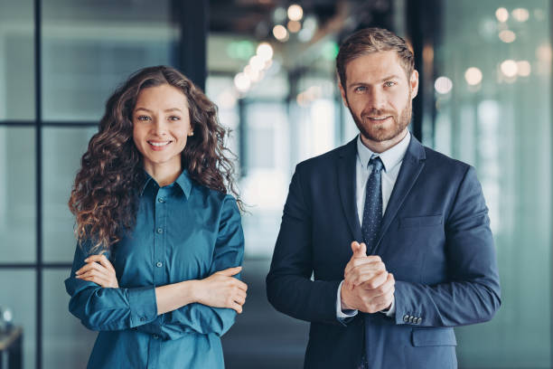businessman-and-businesswoman-standing-side-by-side-in-the-office