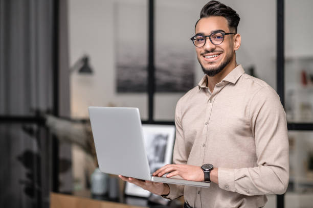 good-mood-a-young-businessman-with-a-laptop-looking-cotented
