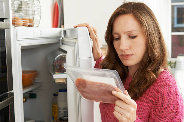 concerned-woman-looking-at-pre-packaged-meat