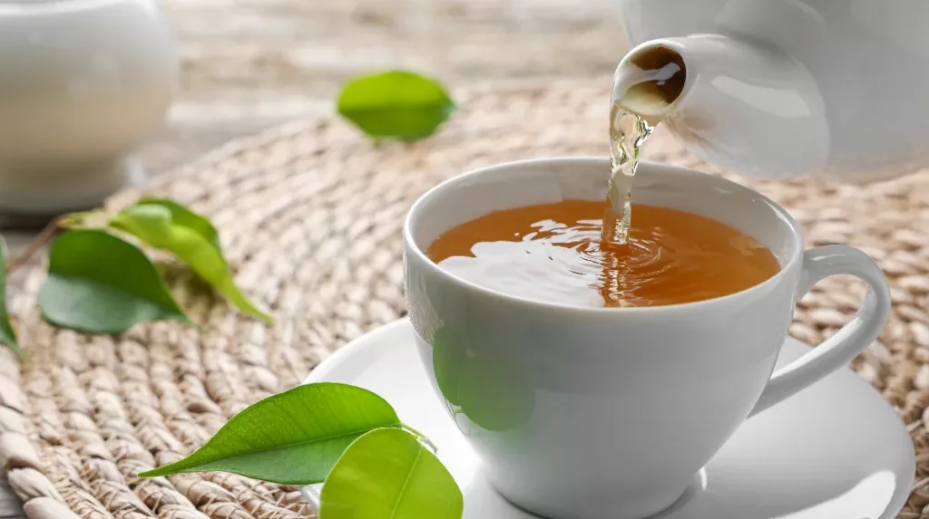 pouring-green-tea-into-tea-cup