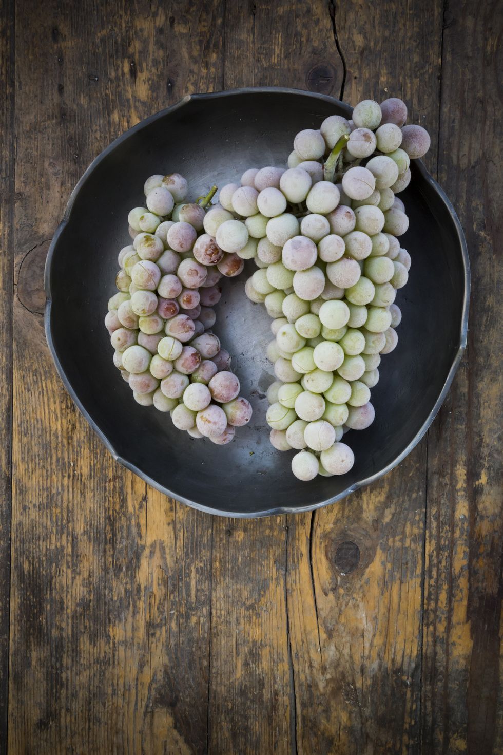 bowl-of-deep-frozen-grapes-on-wood-royalty-free-image-531202829-1557163407