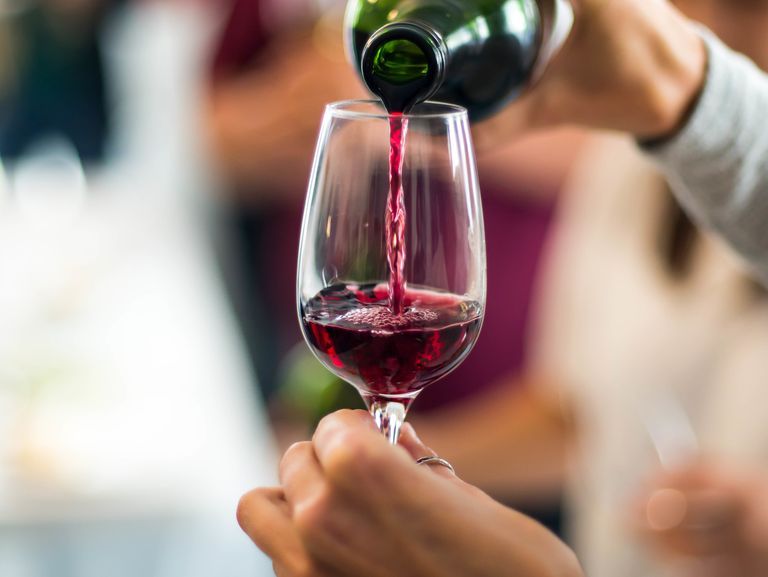 cropped-hands-pouring-red-wine-in-wineglass-royalty-free-image-903896900-1557167067