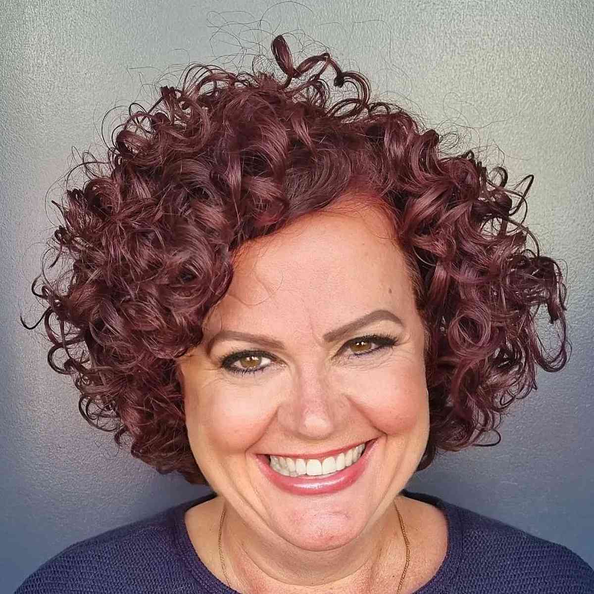 dark-magenta-bouncy-curls-for-ladies-50-and-over-with-round-faces