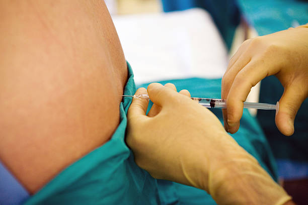 anesthetist-injects-anesthetic-into-a-patients-spine