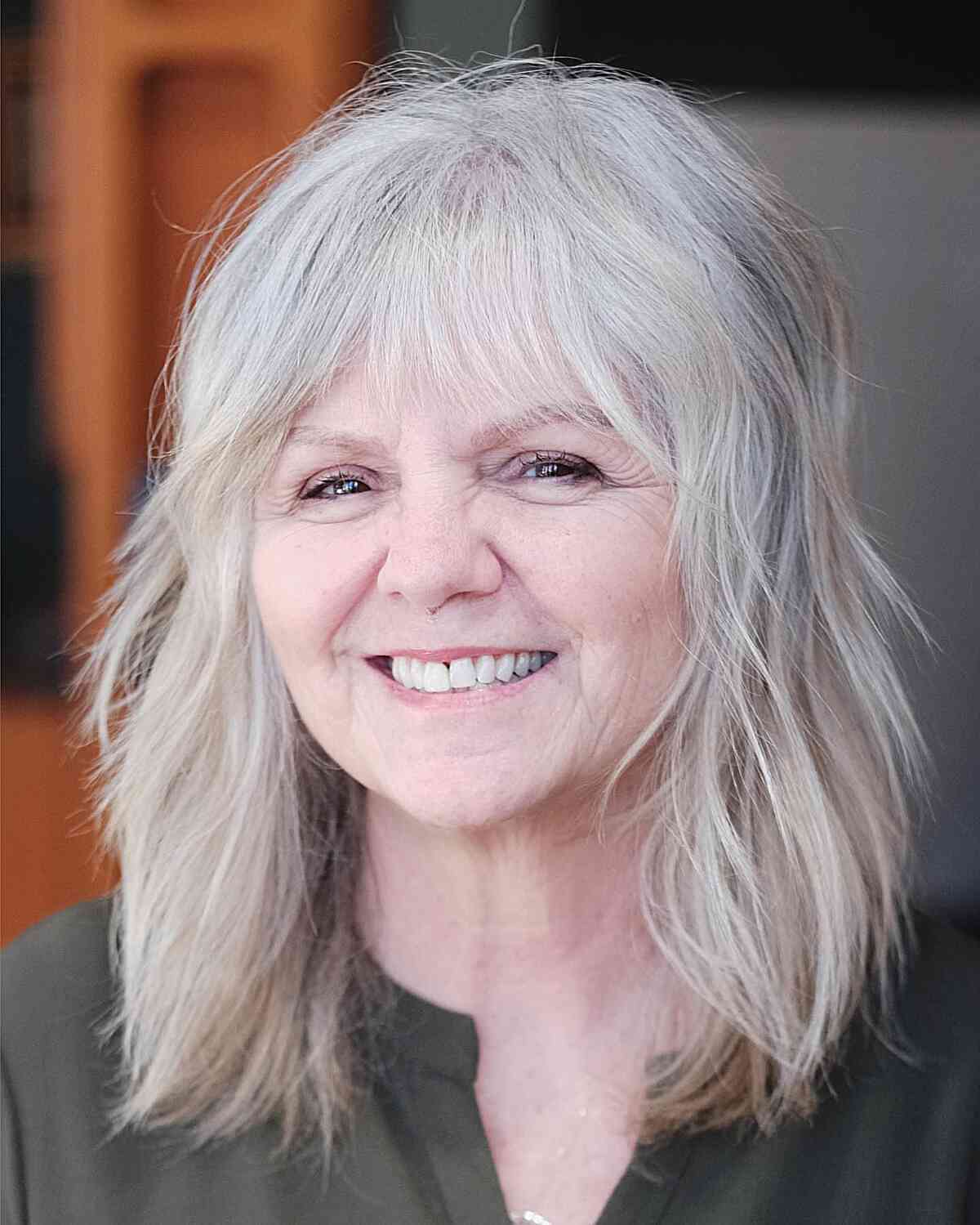 layered-shaggy-medium-length-cut-for-round-faced-women-aged-60