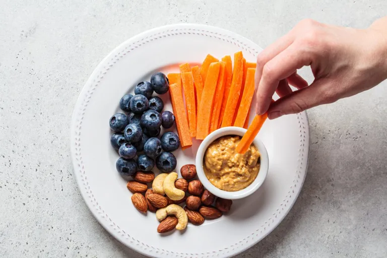 snack-plate-carrots-peanut-butter-nuts-blueberries-e1660794700941