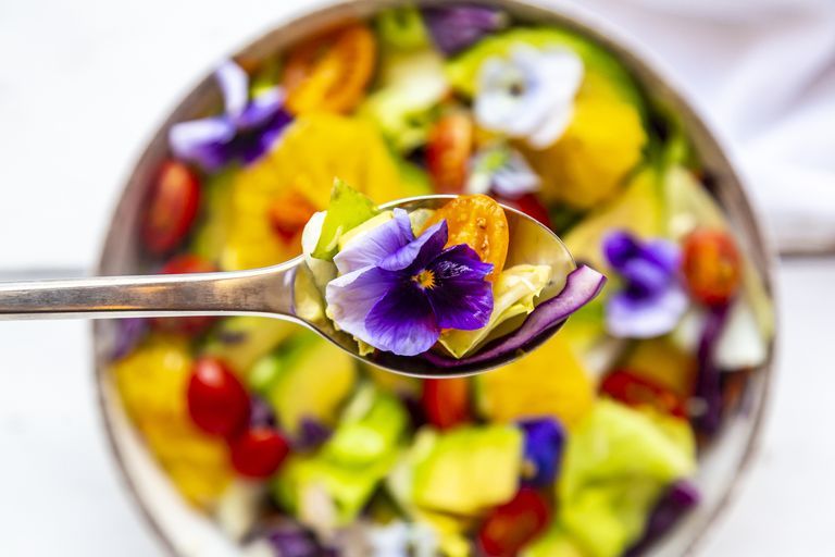 spoon-of-mixed-salad-with-avocado-tomatoes-and-royalty-free-image-1125586325-1557165148