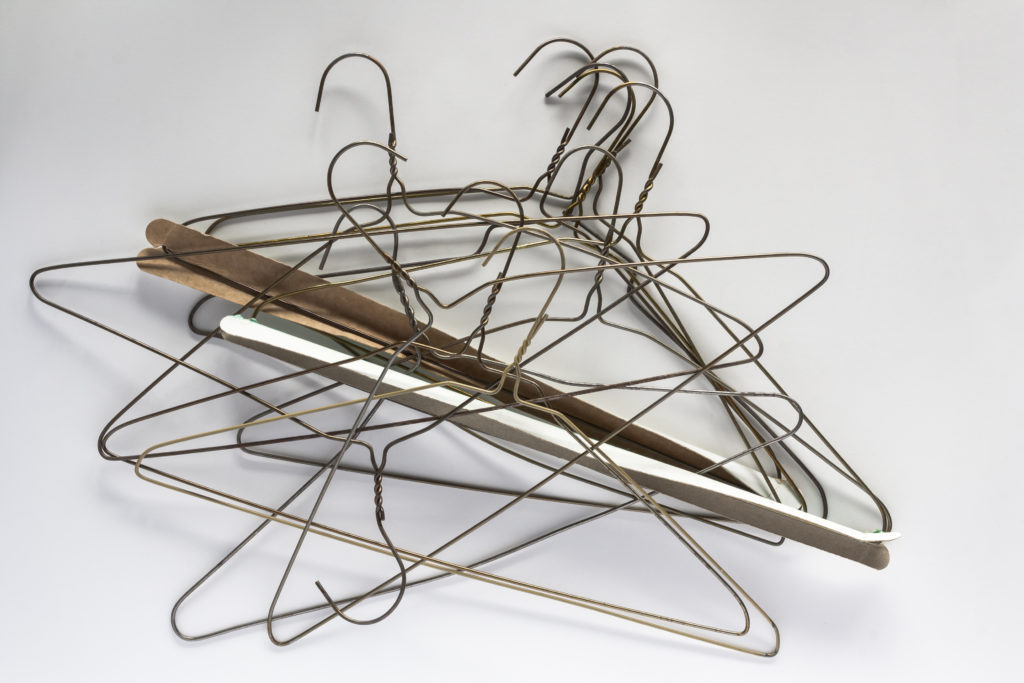 jumble-of-wire-clothes-hangers-isolated-on-white-background