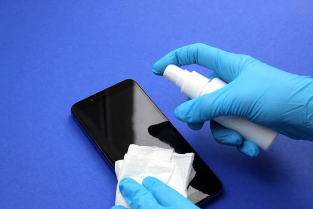 cell-phone-female-hands-in-gloves-are-cleaned-with-an-antiseptic
