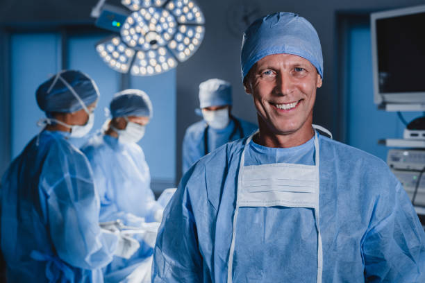 portrait-of-male-surgeon-with-team-of-doctors-on-background-in-operation-room