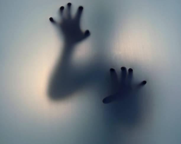 grunge-image-of-blurred-figure-holding-up-hand
