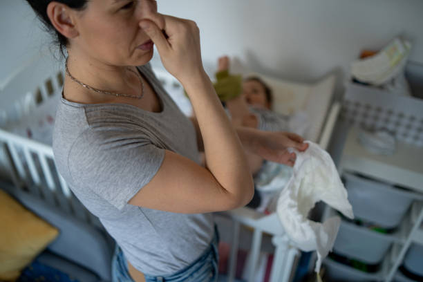 mother-changes-dirty-diaper-to-little-baby-at-home