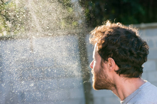 man-sneezing-without-a-mask-sneeze-spray-cloud-backlight-airborne-germs