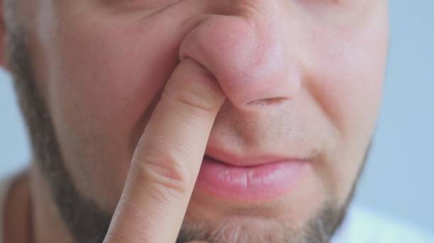 adult-caucasian-male-picking-nose-with-index-finger