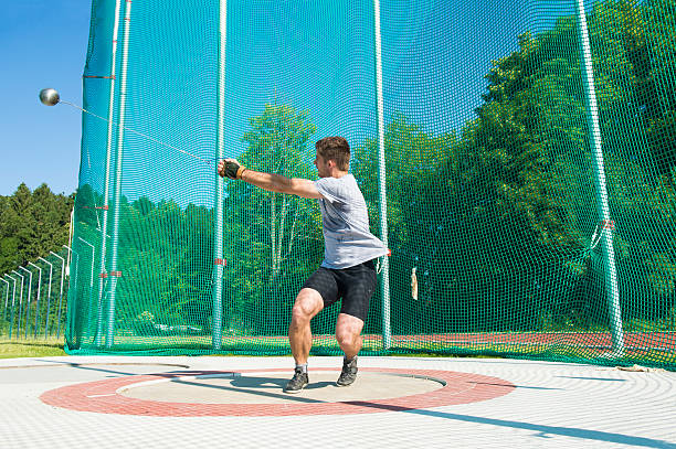 side-view-of-young-man-throwing-hammer