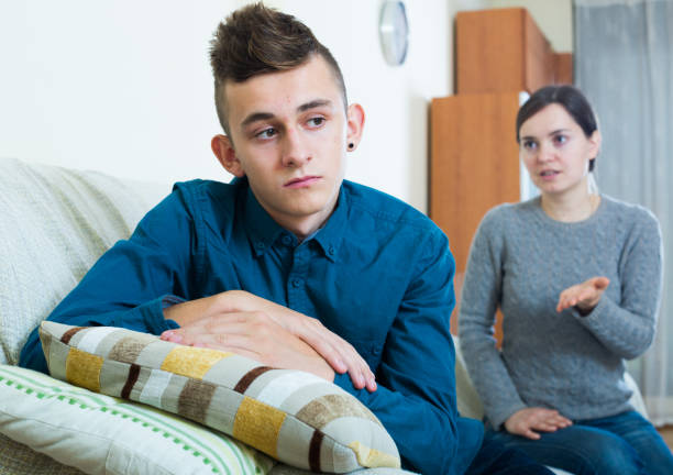 serious-mother-lecturing-unpleased-teenager-in-home-interior
