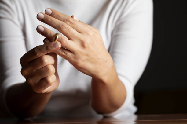 hands-of-caucasian-female-who-is-about-to-taking-off-her-wedding-ring