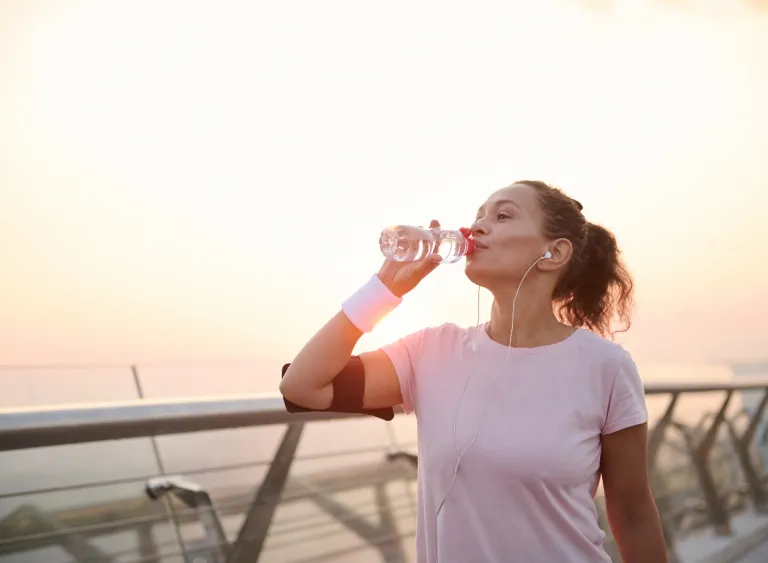 woman-exercising-drinking-water