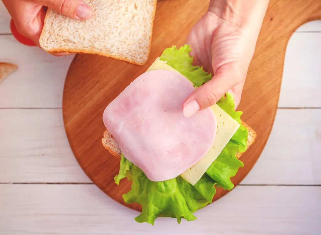 woman-making-sandwich-bread-deli-lunch-meat