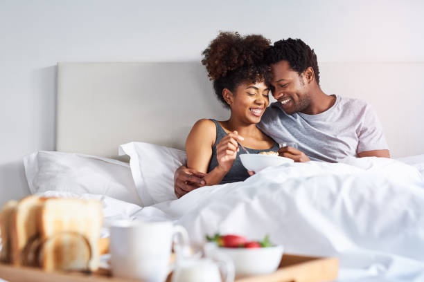 shot-of-a-happy-young-couple-enjoying-breakfast-in-bed