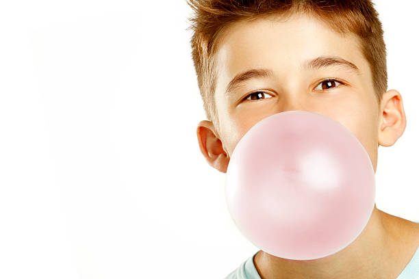 boy-make-bubble-with-chew-on-white-background