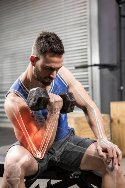 determinated-male-athlete-doing-excercise-with-dumbbells-at-gym