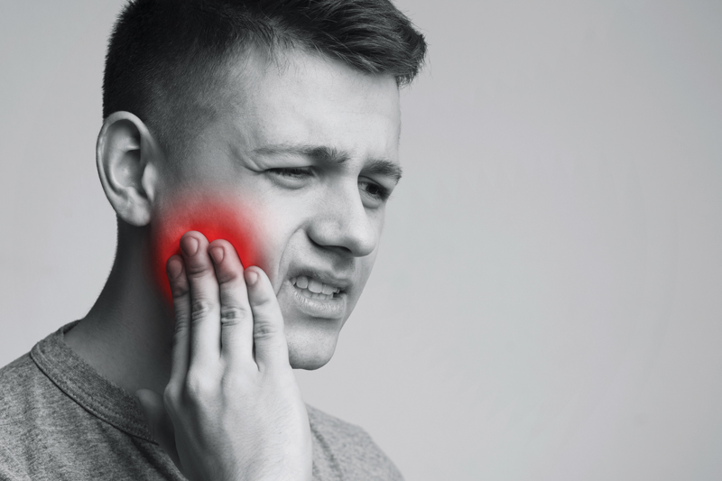 man-suffering-from-strong-tooth-pain-monochrome-photo