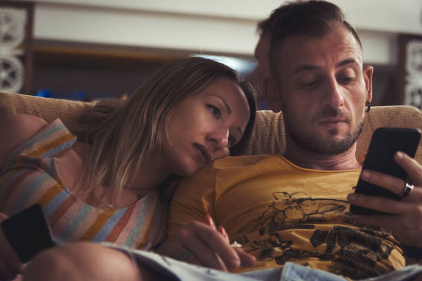 couple-using-mobile-phone-in-hotel-lobby