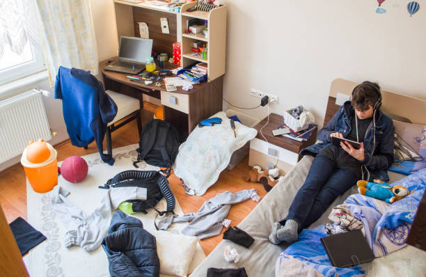 teenager-is-using-tablet-in-his-messy-room