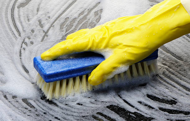 scrubbing-the-floor-with-a-brush-and-rubber-gloves
