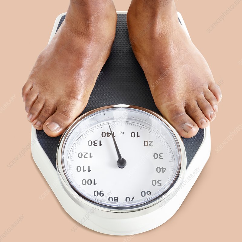 man-standing-on-weighing-scales